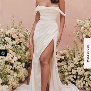 Ivory draped corset bridal gown. Slightly dusk blemish at bottom. Never worn.